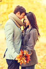 Image showing romantic couple kissing in the autumn park