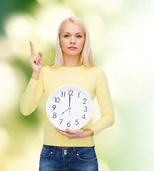 Image showing student with wall clock and finger up