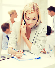 Image showing businesswoman with phone in office