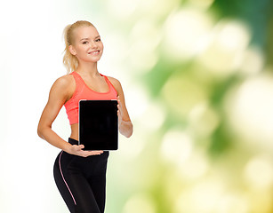 Image showing smiling woman showing tablet pc blank screen