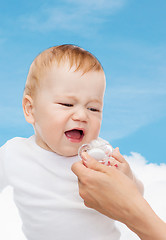 Image showing crying baby with dummy