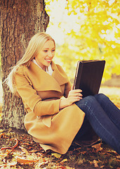 Image showing woman with tablet pc in autumn park