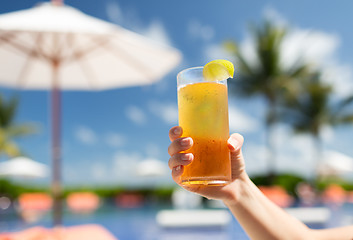 Image showing close-up of hand holding glass with cocktail