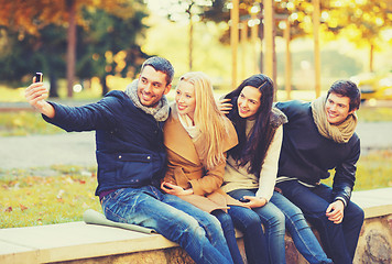 Image showing group of friends taking selfie in autumn park