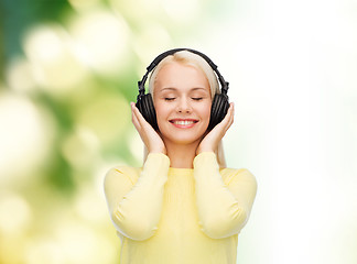 Image showing smiling young woman with headphones