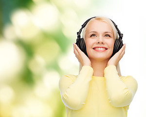 Image showing smiling young woman with headphones