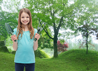 Image showing smiling little girl with rake and scoop