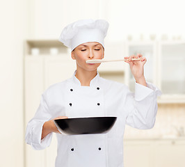 Image showing smiling female chef with pan and spoon