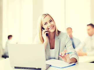 Image showing businesswoman with phone in office