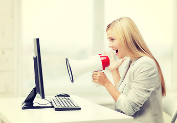 Image showing strict businesswoman shouting in megaphone