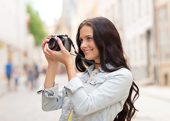 Image showing smiling teenage girl with camera