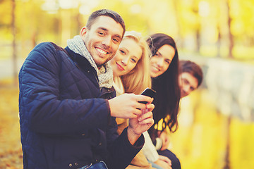 Image showing group of friends having fun in autumn park