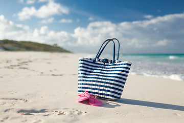 Image showing close up of beach bag and slippers at seaside