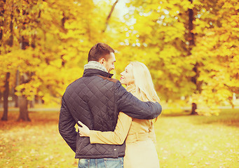 Image showing romantic couple kissing in the autumn park