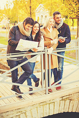 Image showing couples with tourist map in autumn park