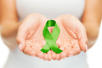 Image showing hands holding green awareness ribbon