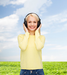 Image showing smiling young woman with headphones