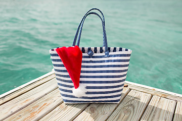 Image showing close up of beach bag and santa helper hat