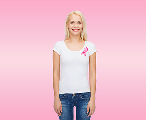 Image showing smiling woman with pink cancer awareness ribbon