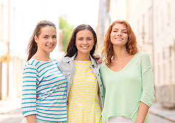 Image showing smiling teenage girls with on street