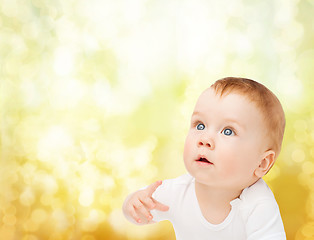 Image showing curious baby looking up