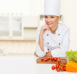 Image showing smiling female chef with vegetables