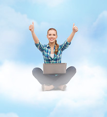Image showing smiling woman with laptop and showing thumbs up