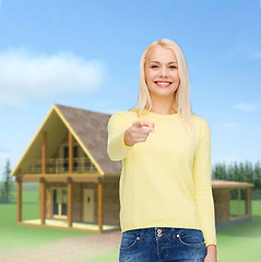 Image showing smiling woman pointing finger at you