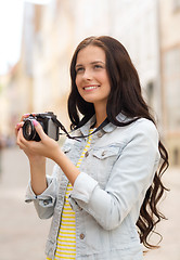 Image showing smiling teenage girl with camera