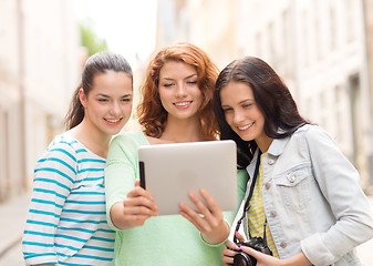 Image showing smiling teenage girls with tablet pc and camera