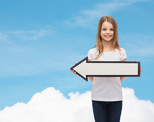 Image showing smiling girl with blank arrow pointing left