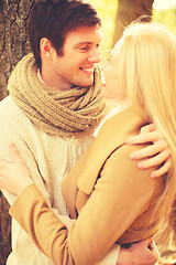 Image showing romantic couple kissing in the autumn park