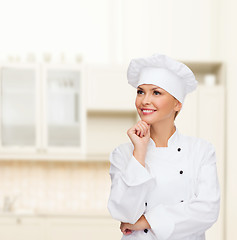 Image showing smiling female chef dreaming