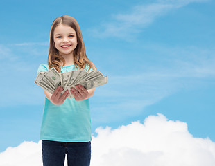 Image showing smiling little girl giving dollar cash money