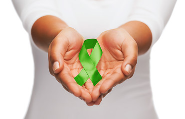 Image showing hands holding green awareness ribbon