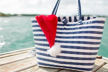 Image showing close up of beach bag and santa helper hat