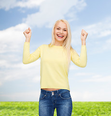 Image showing laughing young woman with hands up