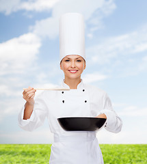 Image showing smiling female chef with pan and spoon