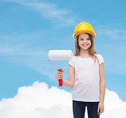 Image showing smiling little girl in helmet with paint roller