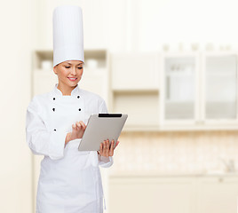 Image showing smiling female chef with tablet pc computer