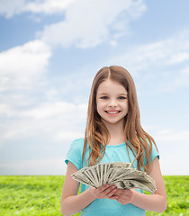 Image showing smiling little girl with dollar cash money