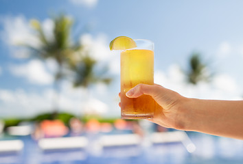 Image showing close-up of hand holding glass with cocktail