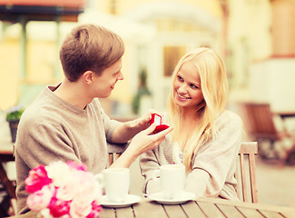 Image showing romantic man proposing to beautiful woman