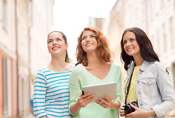 Image showing smiling teenage girls with tablet pc and camera