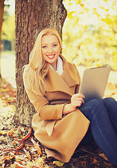 Image showing woman with tablet pc in autumn park