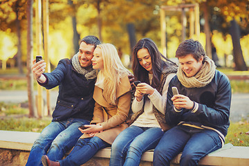 Image showing group of friends having fun in autumn park