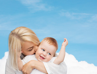 Image showing happy mother kissing smiling baby