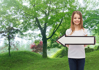 Image showing smiling girl with blank arrow pointing left