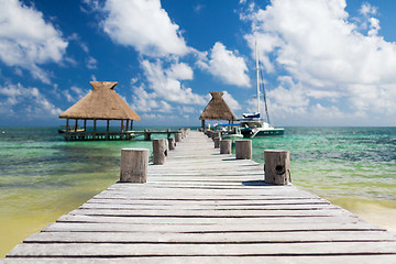 Image showing wooden pier with blue water around