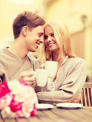 Image showing romantic happy couple kissing in the cafe